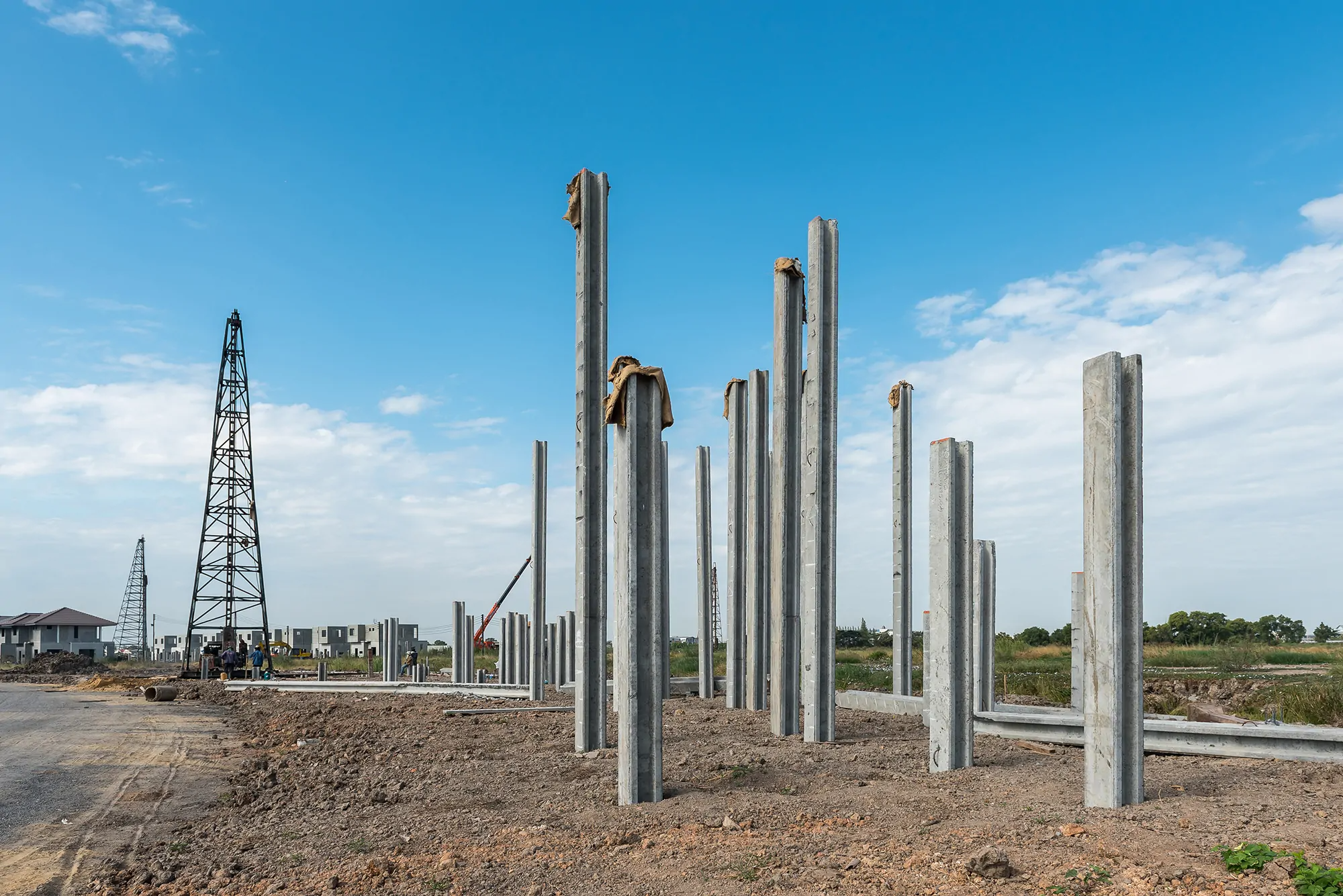 A group of steel poles is seen at a construction site